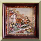 A31. Framed needlepoint of an English cottage. 18” x 13”. Frame measures 23” x 18” - $120 
